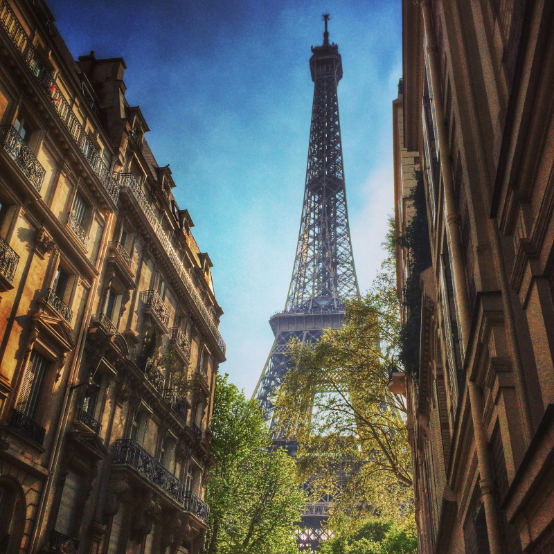France, Paris, Eiffel Tower seen in between townhouses